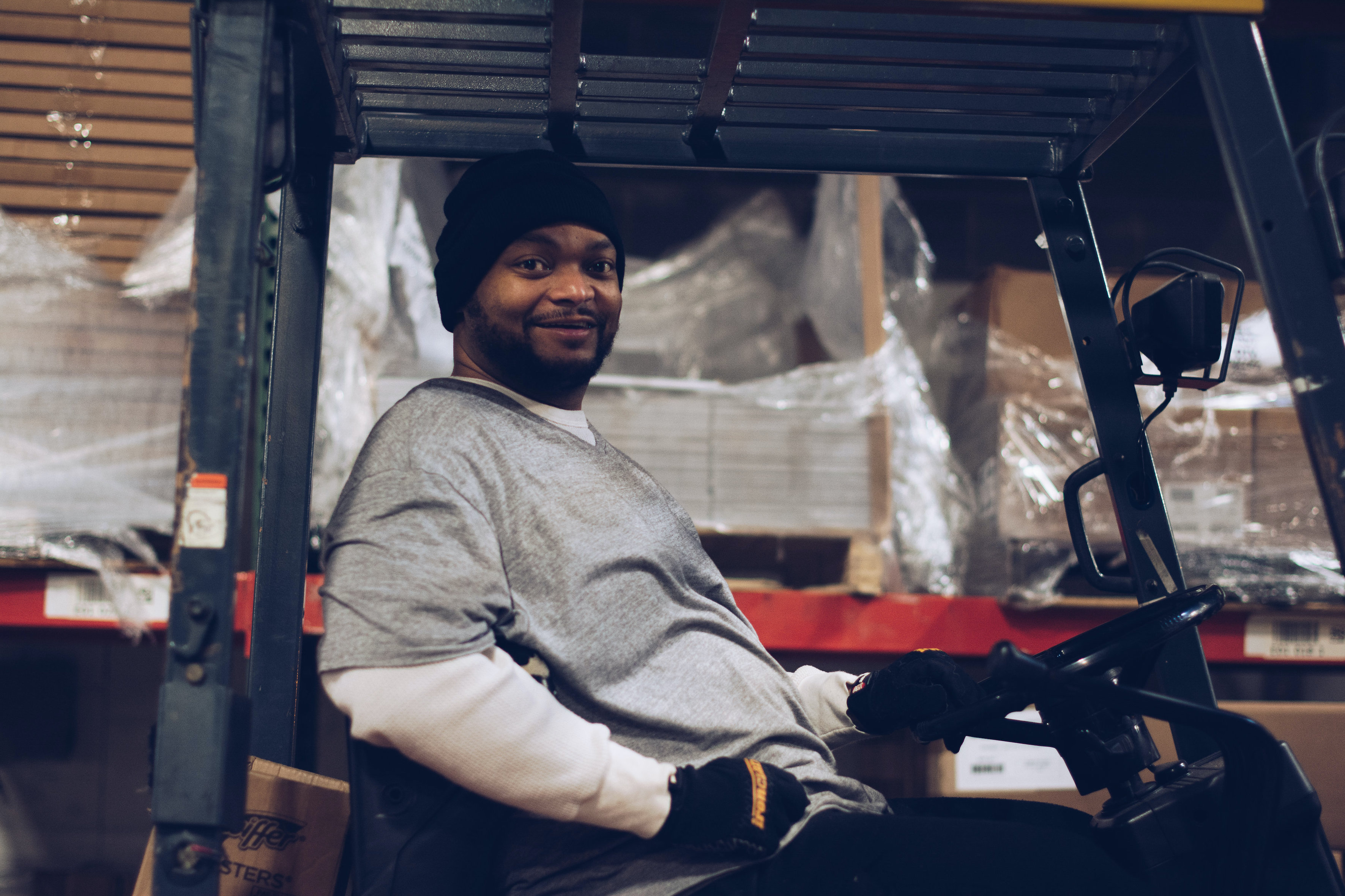 Man working in a warehouse supported by First Step Staffing. The non-profit helps people facing barriers to employment find jobs